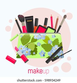 Cosmetic bag with a pattern of blue flowers. Cosmetic bag with tools for professional make-up: lipstick, mascara, eyeshadow and cosmetic brush.