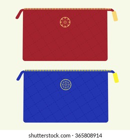 Cosmetic bag from stitched fabric with golden zipper and emblem in red and blue colors