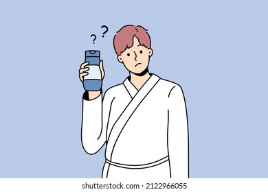 Cosmetics and treatments for men concept. Young man wearing bathtub standing cosmetic bottle in hands with question mark nearby vector illustration 