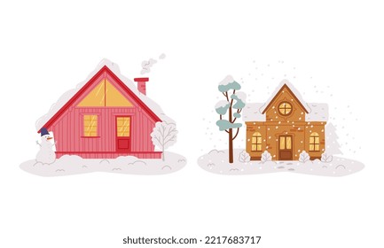 Cosy small wooden houses with glowing windows and snowy rooftops set flat vector illustration