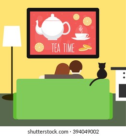 Couch. Couple on couch. Television and advertising. Couple and cat looking tv on couch. Tea time. People, cat. Isolated couple on couch and tv. Family and television. Cat on couch. Green couch and tv
