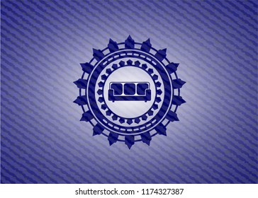 couch icon inside emblem with denim texture