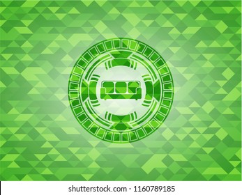 couch icon inside green emblem with triangle mosaic background