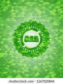 couch icon inside green emblem with triangle mosaic background