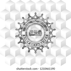 couch icon inside grey badge with geometric cube white background