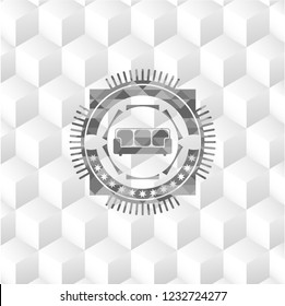couch icon inside grey badge with geometric cube white background