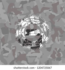 couch icon inside grey camouflaged emblem