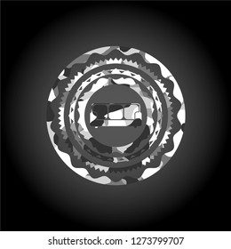 couch icon inside grey camouflaged emblem