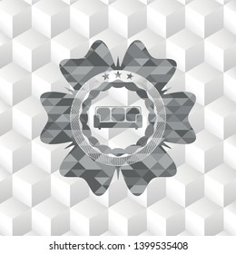 couch icon inside grey emblem with cube white background