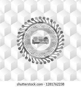 couch icon inside realistic grey emblem with geometric cube white background