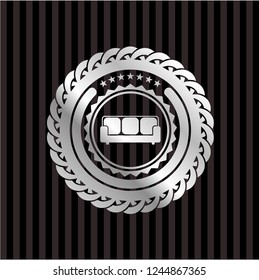 couch icon inside silver emblem or badge