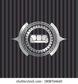 couch icon inside silver shiny emblem. 