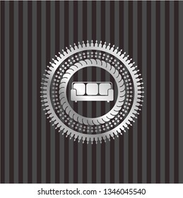 couch icon inside silvery emblem or badge