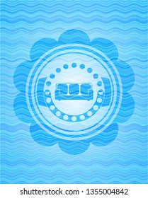 couch icon inside sky blue water emblem background.
