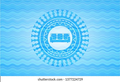 couch icon inside sky blue water wave badge.