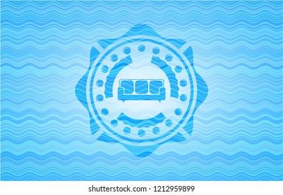 couch icon inside water concept badge.