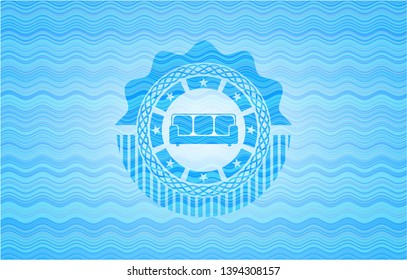 couch icon inside water style emblem.