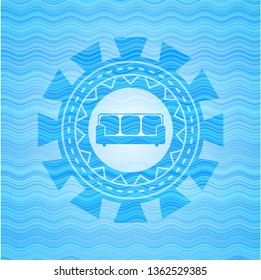 couch icon inside water wave representation badge background.