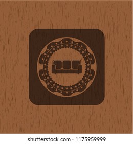 couch icon inside wood badge or emblem