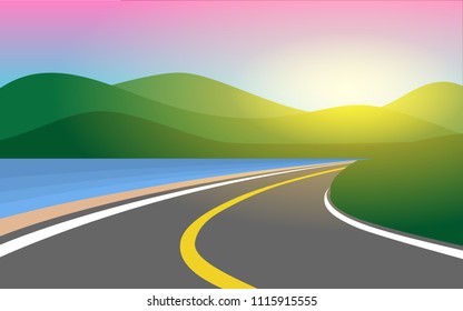 Country side road near the beach and tropical sea lead into the green mountain range with sun ray in the sky in the early morning or sunset time for wallpaper,background,banner,backdrop