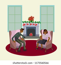 Couple in armchairs in front of fireplace decorated for Christmas. 