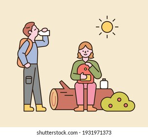 A couple is backpacking. They are sitting on a log and drinking water and resting. flat design style minimal vector illustration.