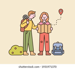 A couple is backpacking. They are standing on the road and looking at the map. flat design style minimal vector illustration.