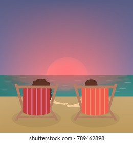 Couple at the beach watching sunset sitting.
