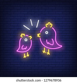 Couple of birds neon sign. Two pink birds with yellow crest twittering to each other on brick wall background. Vector illustration in neon style for topics like love, spring, nature