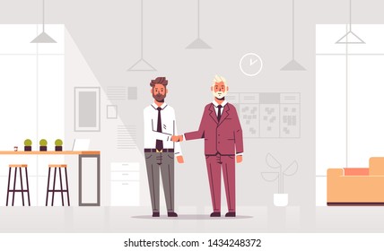 couple businessmen handshaking business partners hand shake during meeting agreement partnership concept colleagues standing in co-working center modern office interior flat full length horizontal