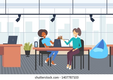 couple businesswomen colleagues discussing during coffee break mix race business women sitting at workplace communication concept modern office interior flat full length horizotal