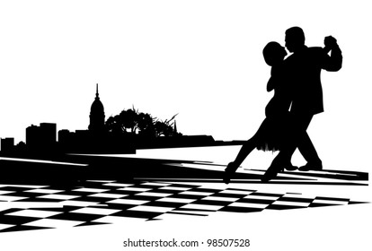 Couple dancing the tango agains  the backdrop of city buildings and trees