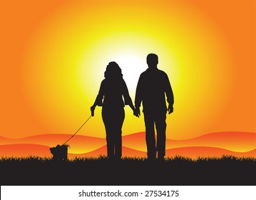 Couple dog walking in the sunset