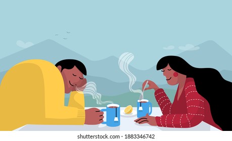 Una pareja toma té en la terraza en la naturaleza con el paisaje montañoso al fondo.