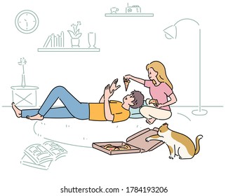 A couple is eating pizza in the living room. A cat is trying to steal pizza. hand drawn style vector design illustrations. 