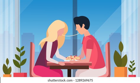 couple eating spaghetti together happy valentines day holiday dinner concept man woman enjoying food modern restaurant interior horizontal flat