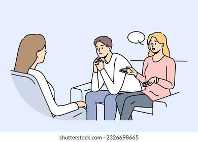 Couple at family therapist in office, sitting on couch talking about problems and quarrels. Woman family therapist helps people get rid of conflicts and misunderstandings in their life together