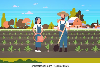 couple farmers planting seedlings plants vegetables man woman gardeners using shovel and watering can agricultural workers eco farming concept farmland countryside landscape horizontal