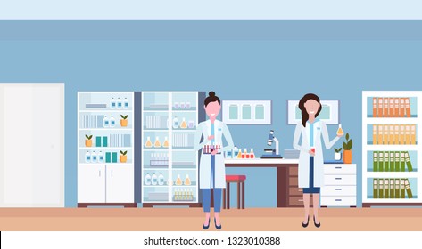couple female scientists working in hospital laboratory. women researchers holding test tubes in workplace. medical clinic lab interior horizontal flat