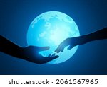 Couple hands reaching to one another on a full moon background, romantic night