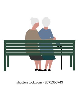 A Couple Of Happy Older Lesbian Women Sit On A Bench Isolated By A White Background. 