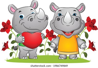 The couple of happy rhino expressing love on the valentine day in the garden of the illustration