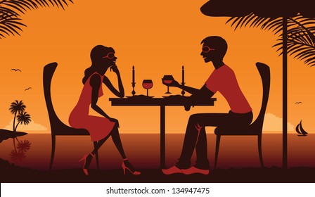 Couple having dinner near the ocean