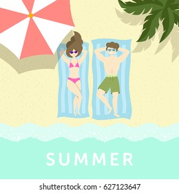 Couple is having sunbathe on the sea shore under palm tree and umbrella.
