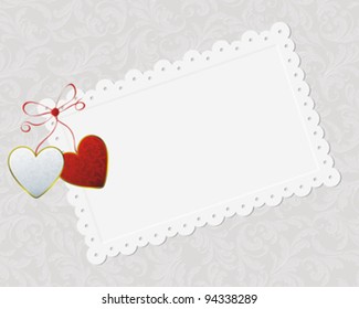 couple of hearts, bound with red ribbon on card on vintage pattern background