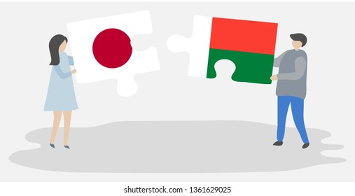 Couple holding two puzzles pieces with Japanese and Malagasy flags. Japan and Madagascar national symbols together.