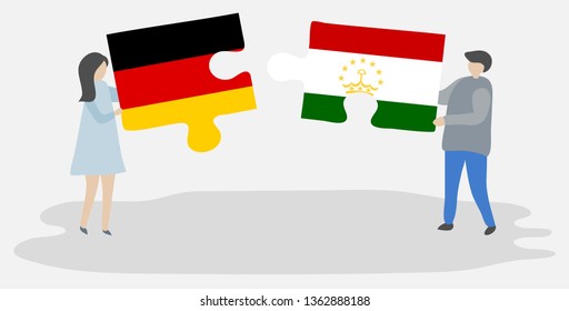 Couple holding two puzzles pieces with German and Tajikistani flags. Germany and Tajikistan national symbols together.