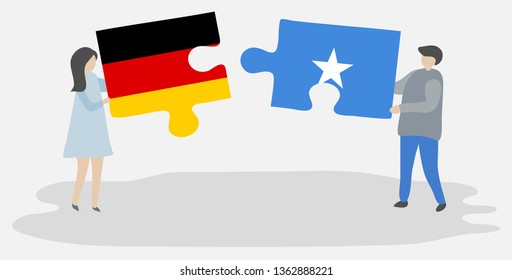 Couple holding two puzzles pieces with German and Somali flags. Germany and Somalia national symbols together.