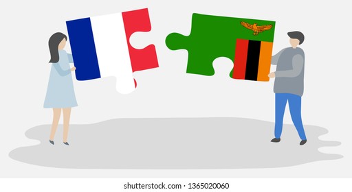Couple holding two puzzles pieces with French and Zambian flags. France and Zambia national symbols together.