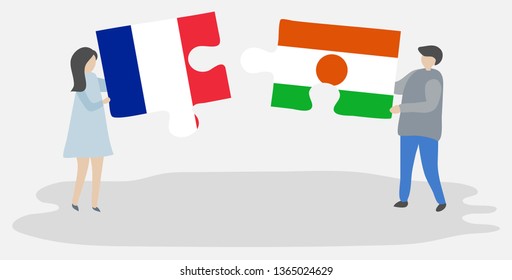 Couple holding two puzzles pieces with French and Nigerien flags. France and Niger national symbols together.